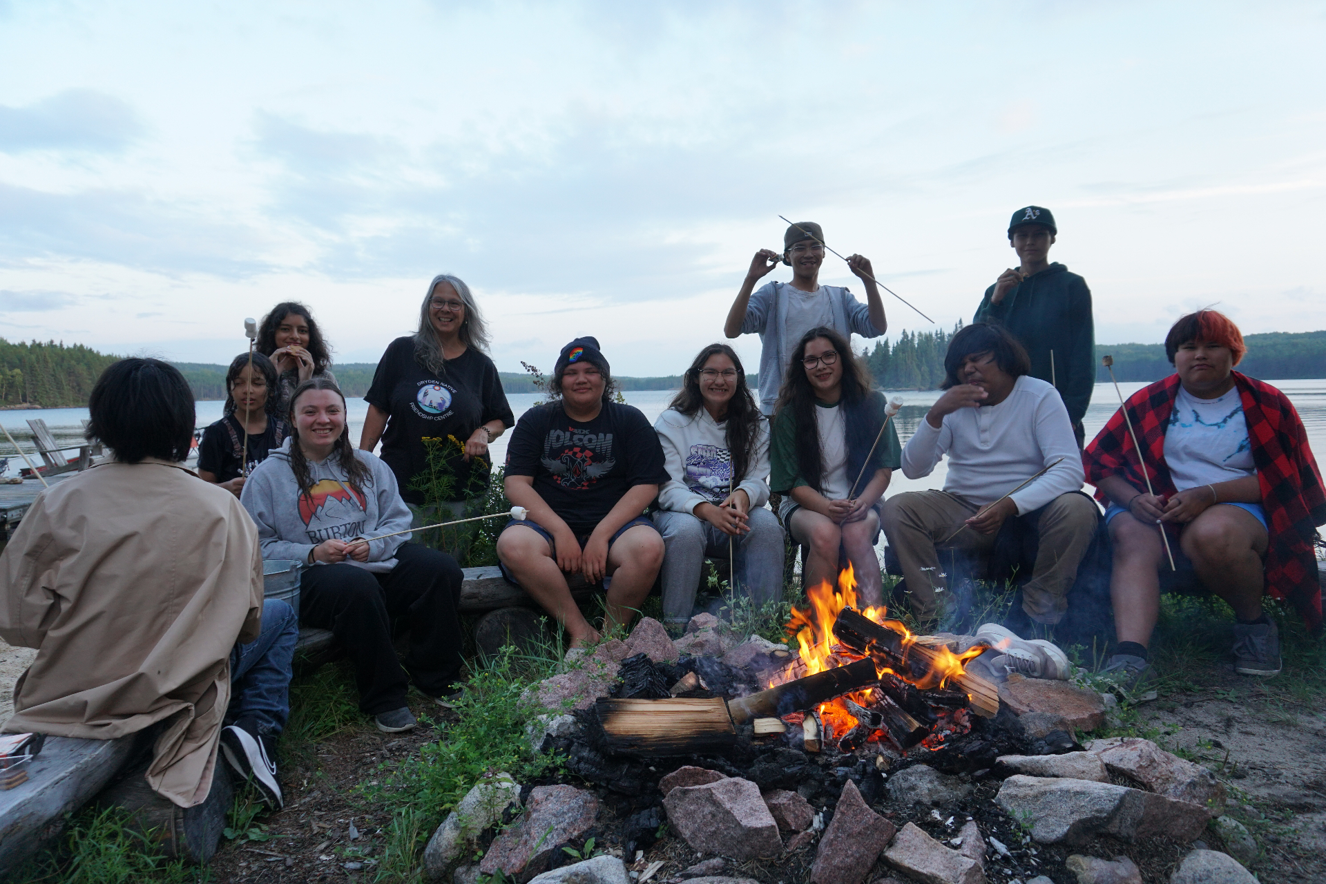 Community circle around a campfire at dusk